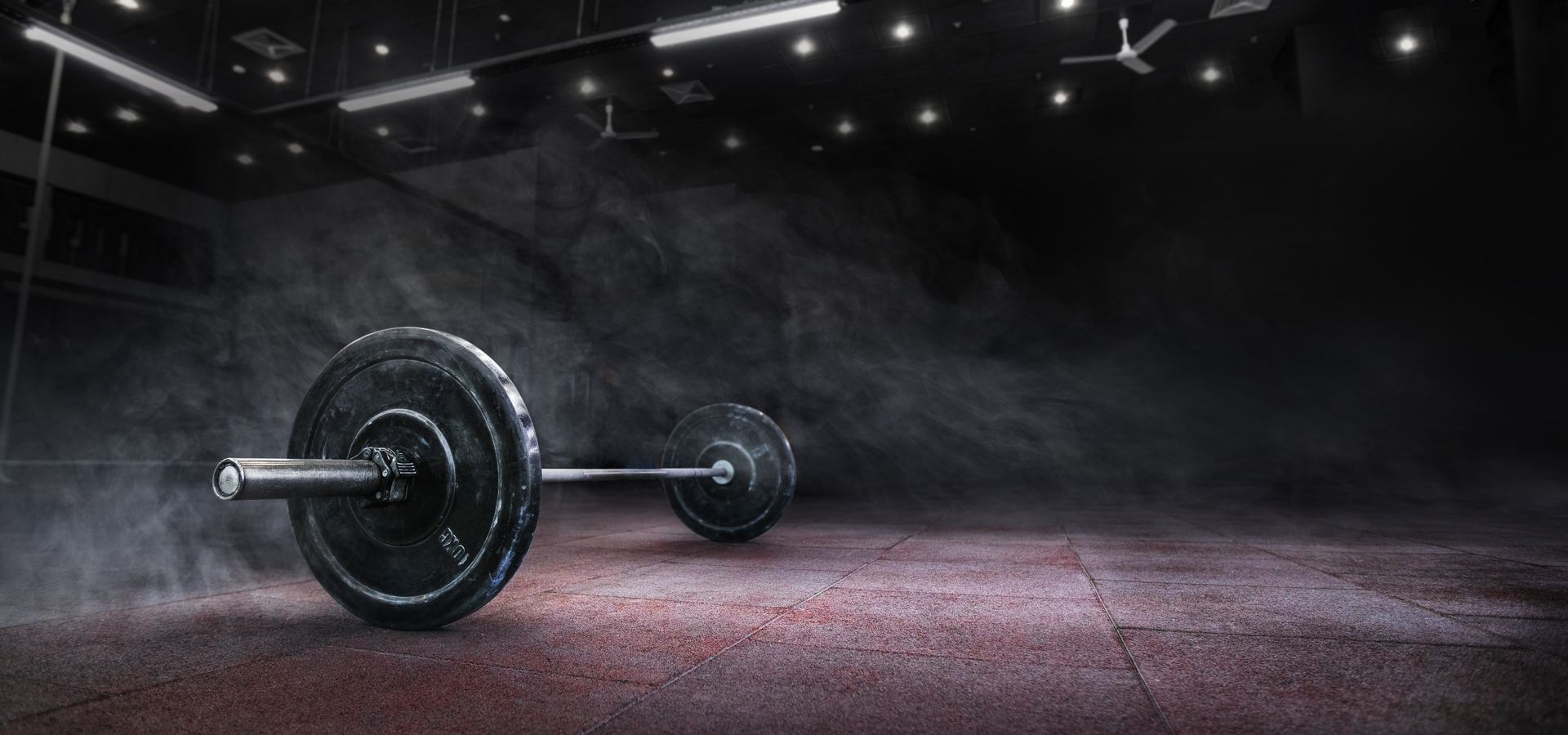Barbell on a dark gym floor